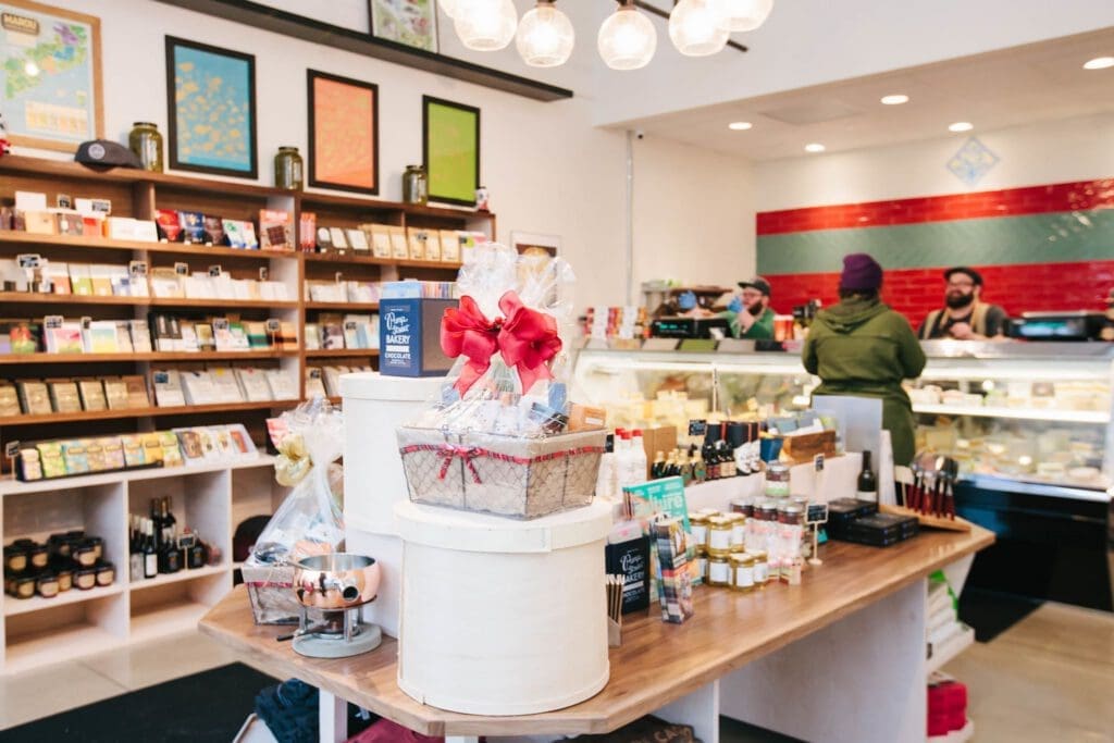 A photo of the inside of Mongers' Provisions Midtown Detroit location. There are displays of wines, cheeses and other fine foods. 