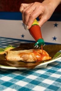 Antojitos El Catracho tamales and hot sauce