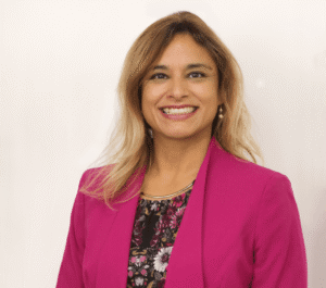Professional headshot of Mayte Penman wearing a pink blazer