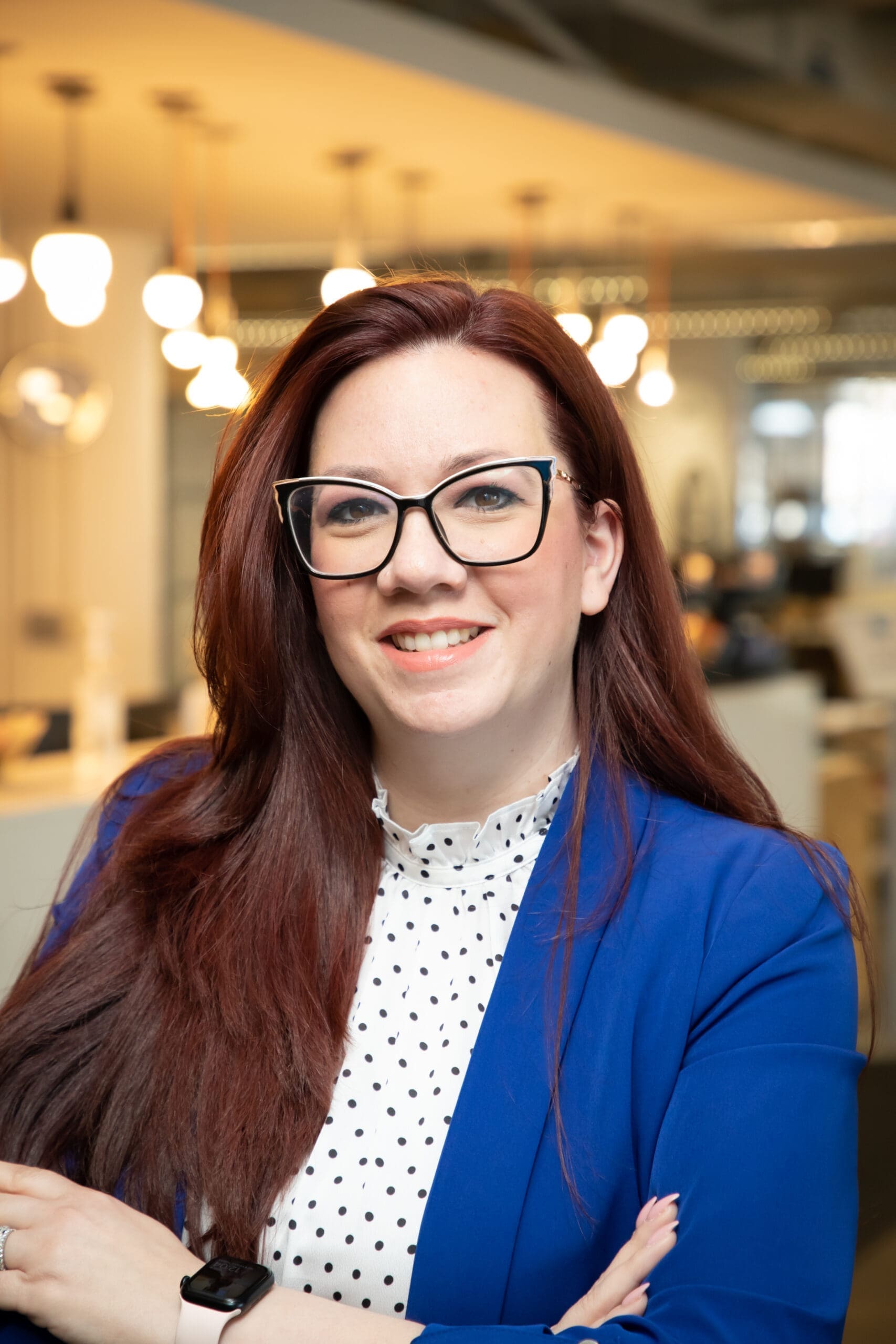 Image of Taharah Saad wearing blue blazer and polka dot blouse.
